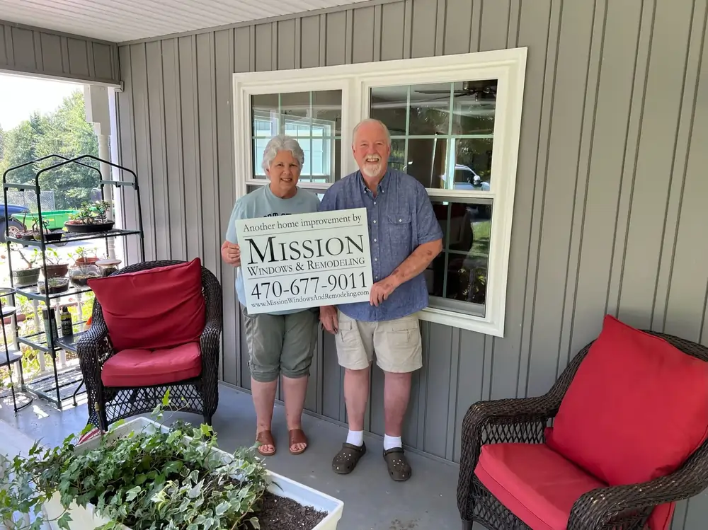 Happy Customers holding Mission Windows Sign